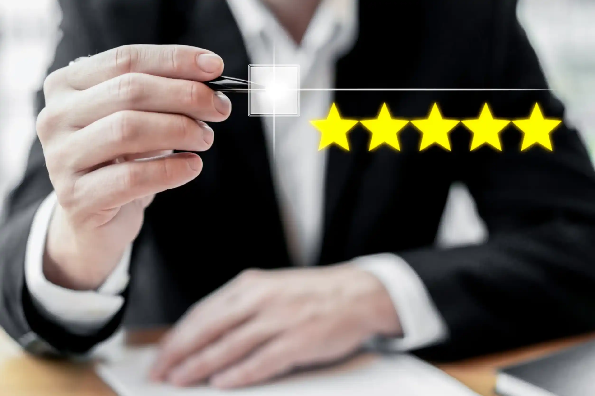 A businessman in a suit selects a glowing star icon, symbolizing rating or feedback, above five yellow stars on a digital interface